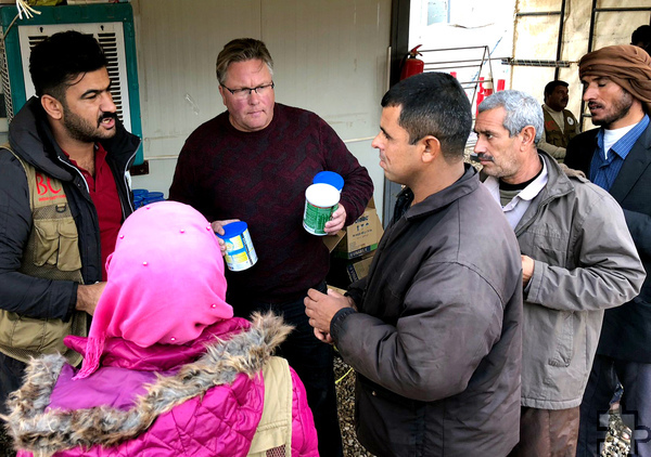 Klemens Hellenthal (M.) beim Verteilen von Trinkwasser im Flüchtlingslager Mossul. Foto: Hilfsgruppe Eifel/pp/Agentur ProfiPress