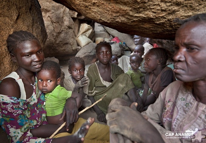 Bei Bombardierungen verstecken sich Menschen in einer Höhle im Sudan. Foto: Cap Anamur/pp/Agentur ProfiPress