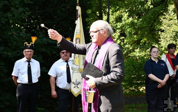 Vor der allgemeinen Totenehrung am Hochkreuz marschierte die Kirmesprozession auch auf den Soldaten- und Kriegsopferfriedhof auf dem Johannesberg. Dort segnete Pfarrer und GdG-Leiter Erik Pühringer nicht nur die Gräber, er berichtete auch, dass und wie die Pfarrjugendlichen die Buntsandsteinkreuze unlängst geschrubbt hatten. Foto: Manfred Lang/pp/Agentur ProfiPress