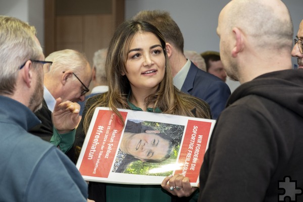 Mit einem Plakat in der Hand, auf dem die Freilassung ihrer Tante Hatun Sahbaz gefordert wird, unterhält sich Pinar Sahbaz im Mechernicher Ratssal mit Journalisten. Foto: Ronald Larmann/pp/Agentur ProfiPress