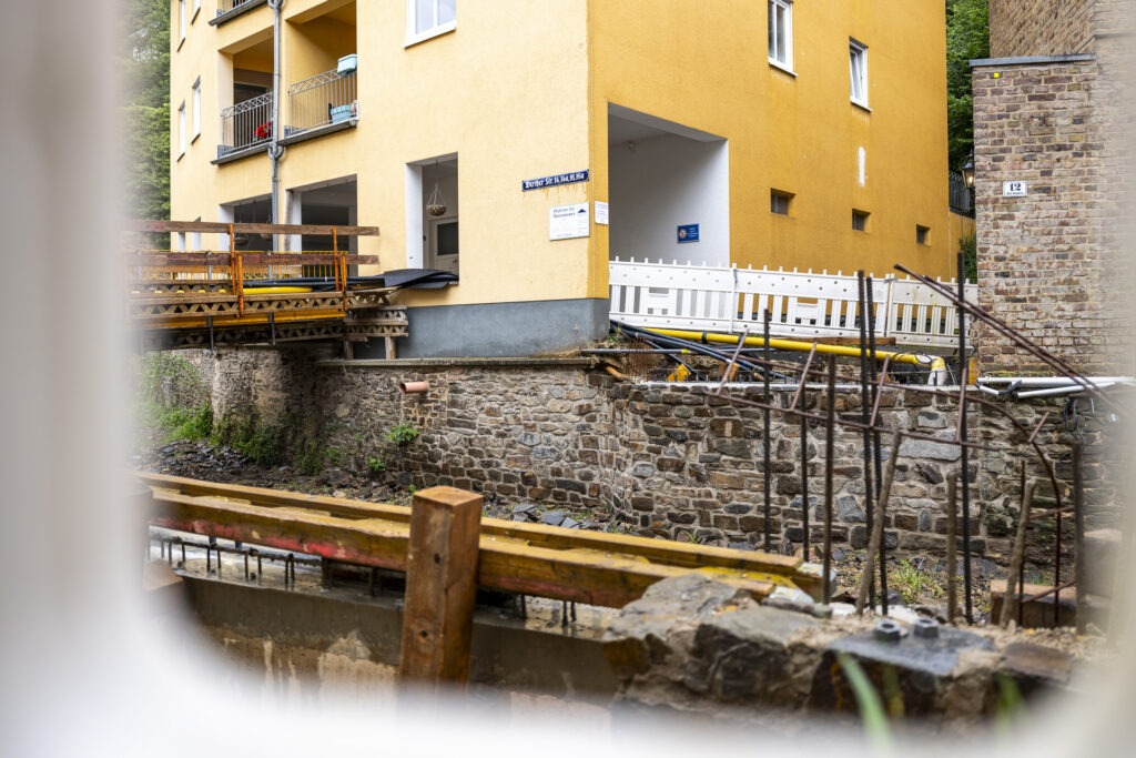 Blick durch eine Baustellen-Bake: Die Widerlager stehen, die neue Brücke in der Werther Straße nimmt Gestalt an und damit werden auch die elf Wohnungen für Seniorinnen und Senioren des Vereins Haus Sonne wieder besser erschlossen. Foto: Ronald Larmann/pp/Agentur ProfiPress